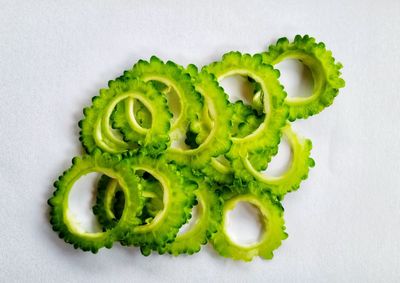 High angle view of green fruit on white background