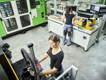 Young woman working on a machine