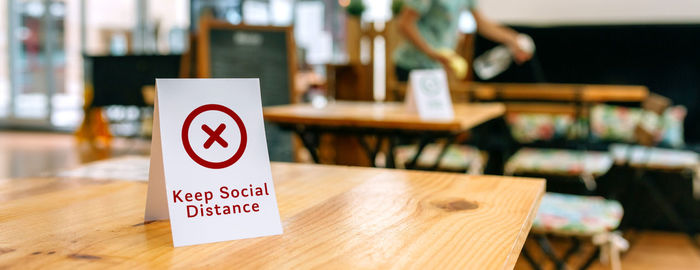 Close-up of information sign on table at restaurant