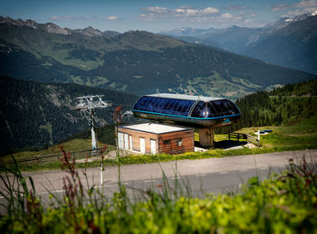 House by mountains against sky