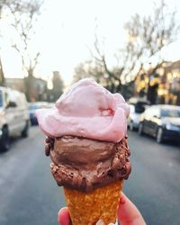 Cropped hand holding ice cream cone