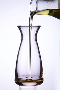 Close-up of liquid in glass jar against white background