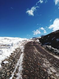 Snow covered mountain against blue sky