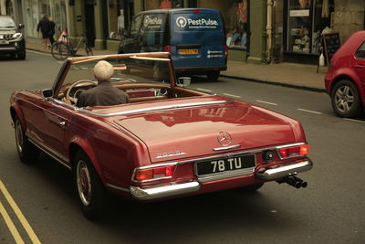 Rear view of vehicles on road in city