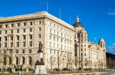 Low angle view of building against blue sky