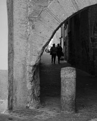 Rear view of woman walking on road