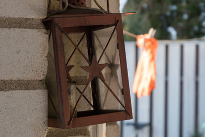 Close-up of lamp hanging on wall