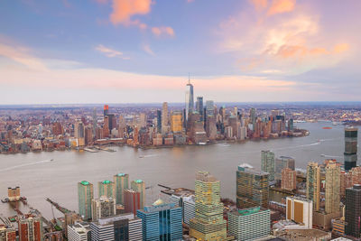 Panoramic view of bay and buildings against sky