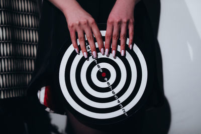 Female hands holding a dartboard