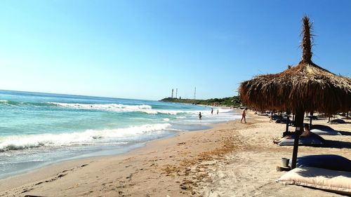 Panoramic view of beach against clear sky
