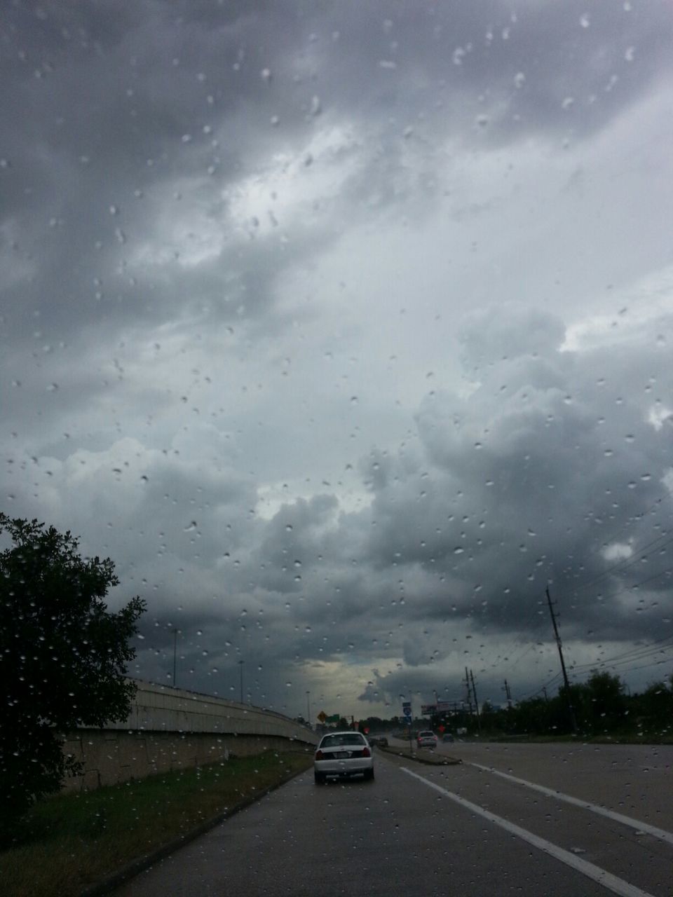 transportation, road, car, sky, land vehicle, road marking, mode of transport, cloud - sky, the way forward, glass - material, transparent, street, weather, cloudy, wet, windshield, on the move, rain, vehicle interior, cloud