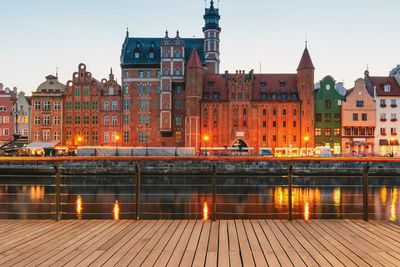 Illuminated buildings in city at dusk