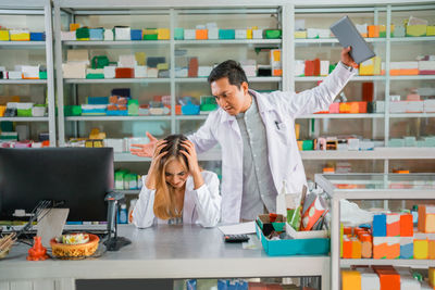 Rear view of female friends standing in store