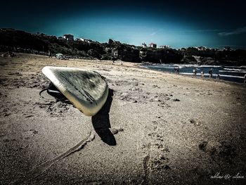 Shadow on sand at beach against clear sky