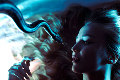 Close-up of young woman drinking water