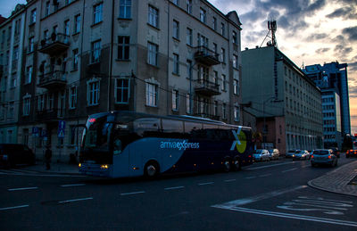 Vehicles on road along buildings