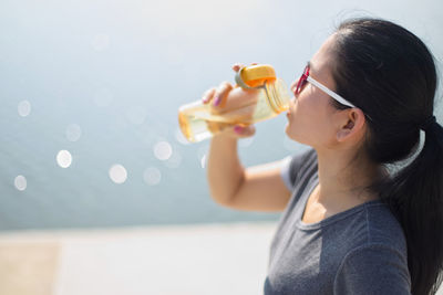 Close-up of woman drinking water from bottle