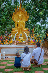 Rear view of buddha statue against temple