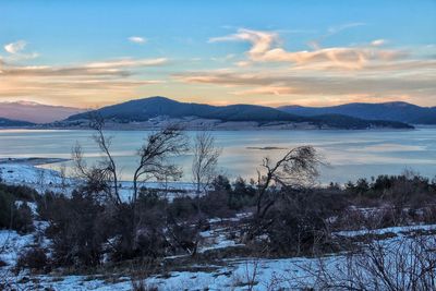Scenic view of lake against dramatic sky