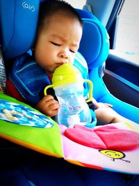 Cute boy sitting in car