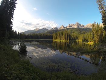 Scenic view of lake and mountains against sky