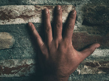 Close-up of hands against wall