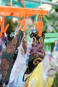 Close-up of clothes hanging at market stall