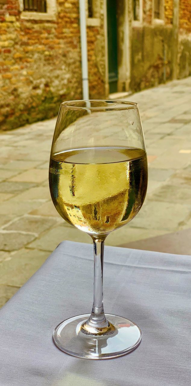 CLOSE-UP OF BEER IN GLASS ON TABLE