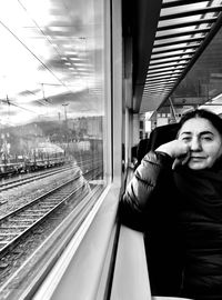 Portrait of man looking through train window