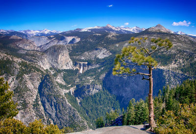 Scenic view of rocky mountains against blue sky