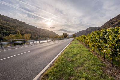 Empty road along countryside landscape