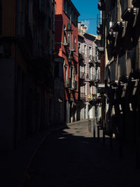 Empty alley amidst buildings in city