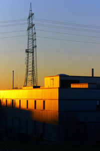 Electricity pylon against sky during sunset