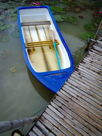 High angle view of empty boat moored at pier