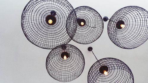 Low angle view of illuminated lanterns hanging against ceiling