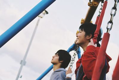 Low angle view of boy playing on playground