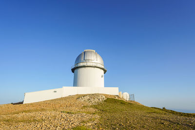 Telescope on top of a mountain in the astrophysical observatory of javalambre, teruel, spain