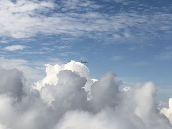 Low angle view of airplane flying against sky