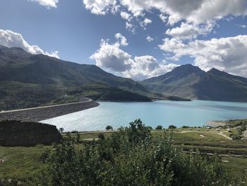 Scenic view of lake and mountains against sky