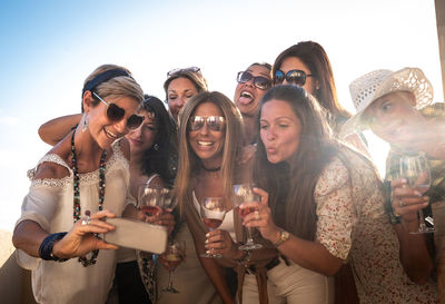 Group of young people drinking glass outdoors