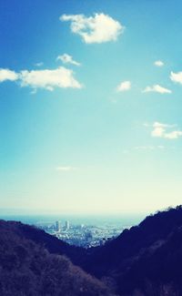 View of cityscape against cloudy sky