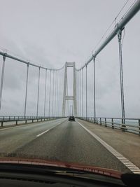 Bridge against sky seen through car windshield