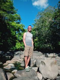 Portrait of young man standing on rock