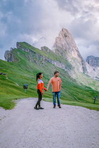 Full length of women standing on mountain against sky