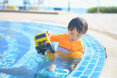 Boy playing in pool