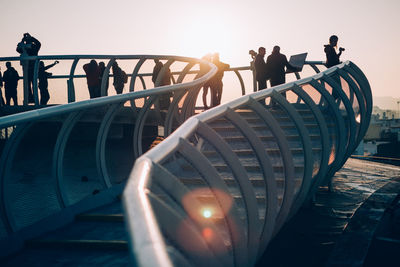 People standing on metropol parasol against clear sky during sunset