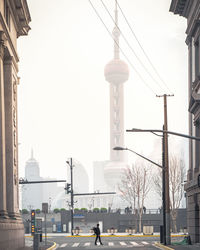 Street amidst buildings against clear sky