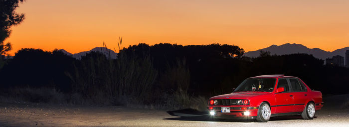 Vintage car against sky during sunset