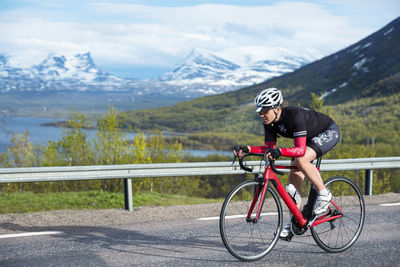 Man riding bicycle on road