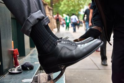 Low section of man wearing black shoes